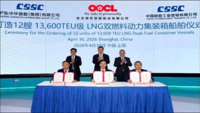 Large OOCL container ship loaded with cargo sails at sea.