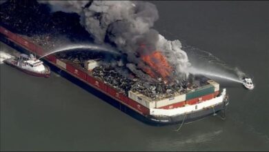 Scrap fire erupts from a barge on the Delaware River.
