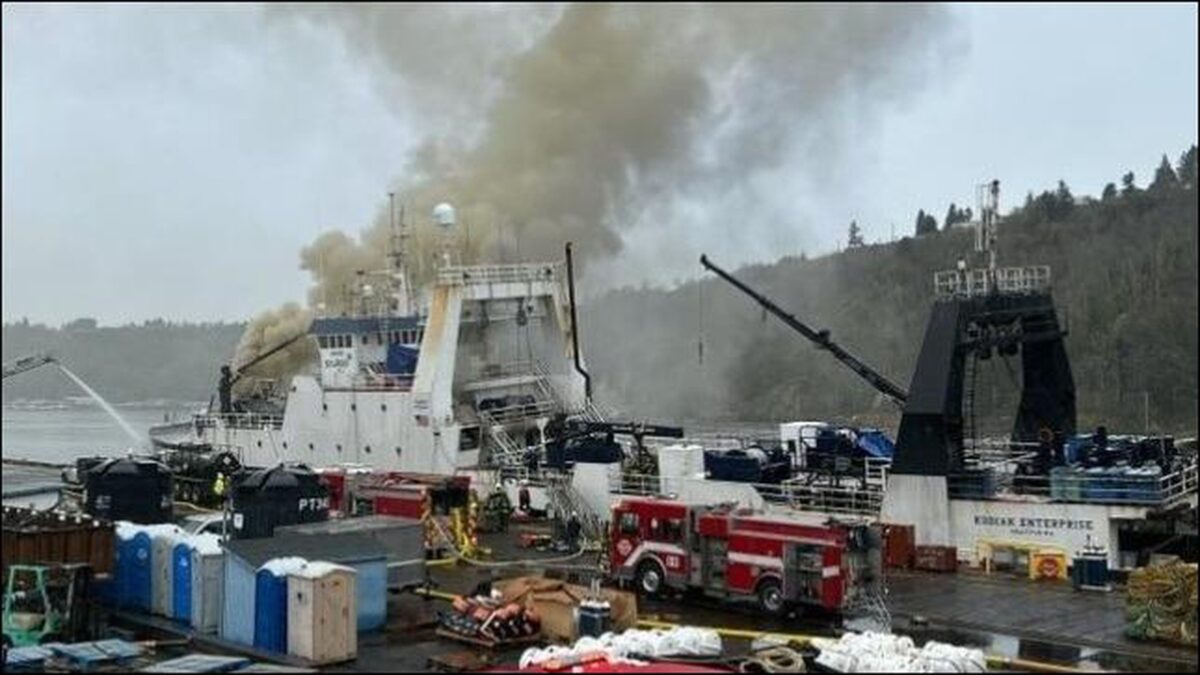 The Kodiak Enterprise fishing vessel burning, engulfed in smoke and flames.