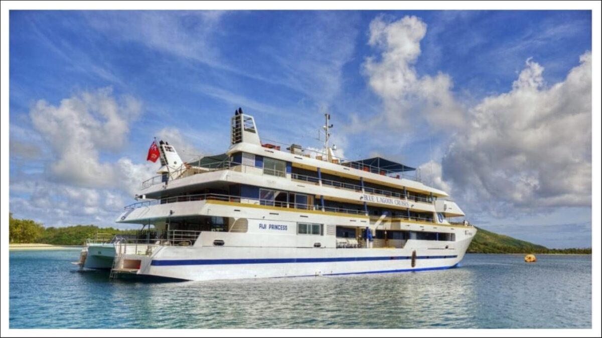 The white and blue Fiji-Princess cruise ship sailing on calm waters.