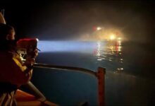 An RNLI lifeboat and crew conduct a critical medical evacuation at sea.