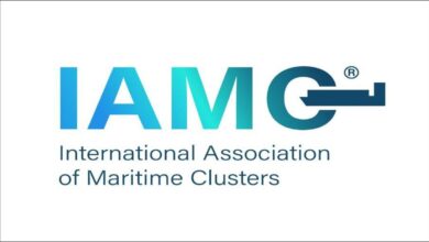 The IAMC logo features a world map graphic on a blue background.