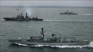 British Royal Navy warship and helicopter deploy to track vessels in the English Channel.