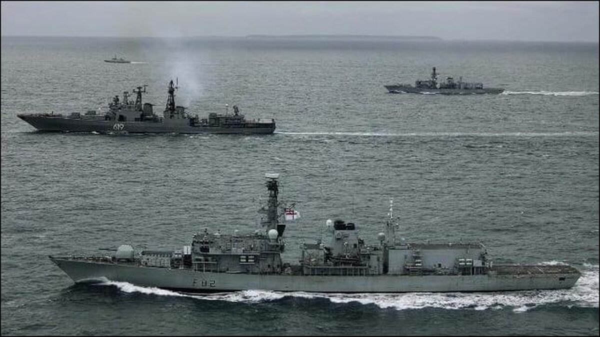 British Royal Navy warship and helicopter deploy to track vessels in the English Channel.