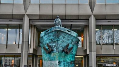 A modern cargo ship sails on the ocean, representing sustainable green shipping solutions.