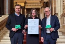 An industrial port facility with multiple storage tanks and a tanker ship, representing an ammonia terminal.