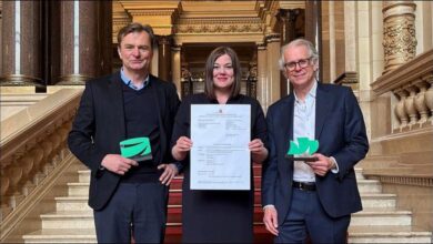 An industrial port facility with multiple storage tanks and a tanker ship, representing an ammonia terminal.