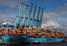 A large Maersk container ship navigates the ocean, symbolizing global shipping operations.