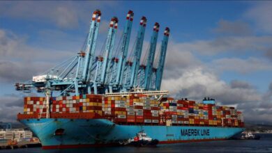 A large Maersk container ship navigates the ocean, symbolizing global shipping operations.