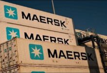 A large container ship crosses open waters, illustrating global shipping and maritime trade.