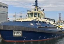 The Svitzer Balder battery-methanol tug sailing on calm waters.