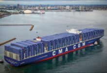 The massive CMA CGM Benjamin Franklin container ship sailing on the ocean.
