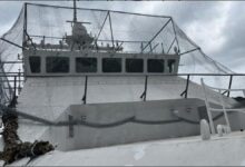 A Russian patrol ship shows improvised netting on its deck for drone defense.