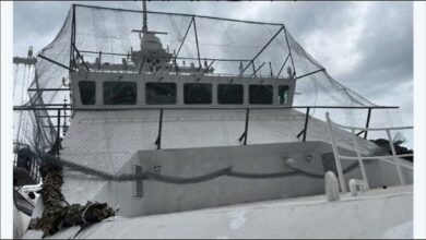 A Russian patrol ship shows improvised netting on its deck for drone defense.