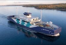 A modern, white fully-electric ferry sails through icy waters in Estonia.