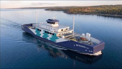 A modern, white fully-electric ferry sails through icy waters in Estonia.