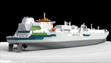 Modern cargo vessel at sea equipped with a carbon capture system.