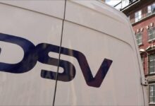 Business professionals in a modern DSV branded office reviewing information.