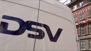 Business professionals in a modern DSV branded office reviewing information.