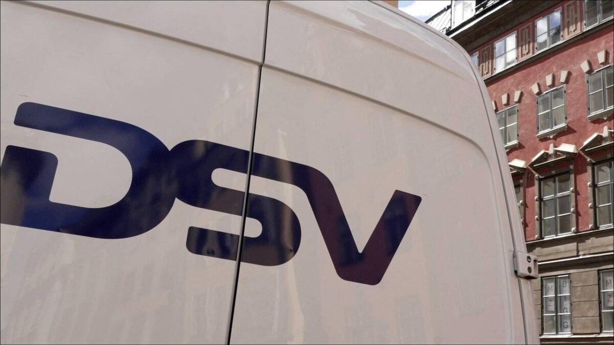 Business professionals in a modern DSV branded office reviewing information.