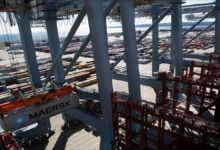 A large Maersk container ship docked in a port.
