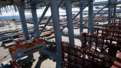 A large Maersk container ship docked in a port.