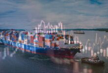 Stacked shipping containers and cranes at a busy logistics port.