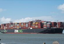 Multiple large container ships filled with cargo docked at a busy port.