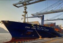 A large CMA CGM container ship sails on the ocean, symbolizing low-carbon shipping.