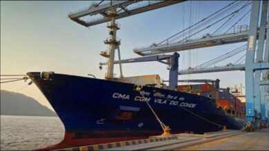 A large CMA CGM container ship sails on the ocean, symbolizing low-carbon shipping.