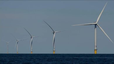 Offshore wind turbines stand tall at sea, symbolizing renewable energy.
