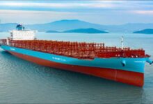 Tsuneishi's new blue and white methanol dual-fuel container vessel sailing at sea.