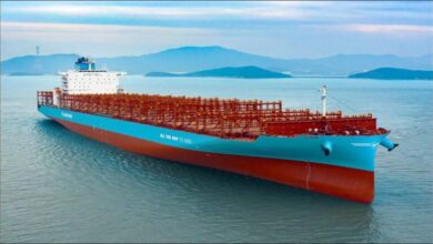 Tsuneishi's new blue and white methanol dual-fuel container vessel sailing at sea.
