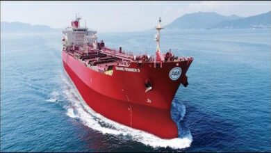 A large Very Large Crude Carrier (VLCC) oil tanker sails on the open sea.