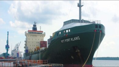 MTT Shipping container vessel at Port Klang with cranes loading cargo.