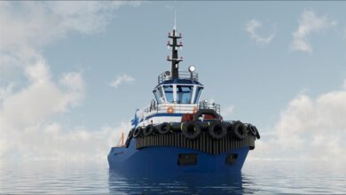 A modern Svitzer electric tugboat sails on calm waters, showcasing green maritime propulsion.