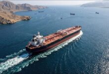 Oil tanker transits the busy Strait of Hormuz, crucial for global supply chains amidst Iran sanctions.