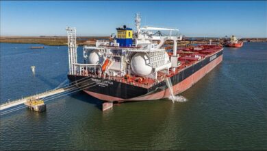 Fortescue and CMB.TECH representatives shake hands, celebrating their partnership for ammonia bulkers.