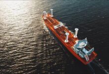 A large cargo vessel at sea equipped with innovative wind-assisted propulsion technology.