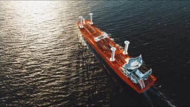 A large cargo vessel at sea equipped with innovative wind-assisted propulsion technology.