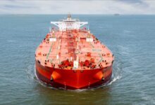A huge crude oil tanker docked, likely loading oil for US exports.