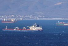 Large cargo ship sailing on the sea, representing global shipping routes.