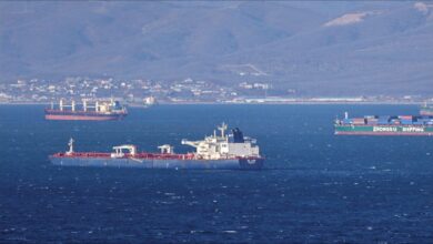 Large cargo ship sailing on the sea, representing global shipping routes.