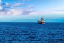 A large oil tanker sails through open waters, representing global crude oil transport.