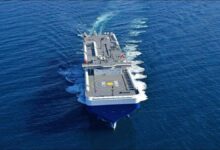 An NYK car carrier ship sails on the ocean, advancing sustainable shipping.