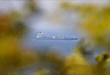 A large oil tanker, central to Gulf state exports, sails through the Strait of Hormuz.