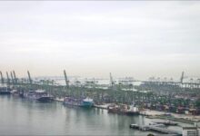 Vessels conducting rescue operations near Singapore's Pasir Panjang Terminal after a fatal collision.