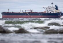 The vessel Kiwala sails on the open sea, symbolizing global shipping and illicit fleets.