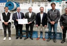 Officials inspect the newly certified BeHydro 100% hydrogen marine engine.