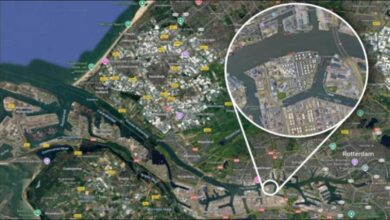 A large ship is docked at a bustling port terminal with fuel tanks, representing marine biofuel operations.